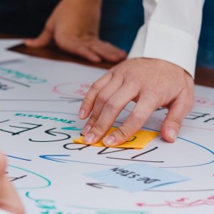 Happy young Asia businessmen and businesswomen meeting brainstorming ideas about new paperwork project colleagues working together planning success strategy enjoy teamwork in small modern office.