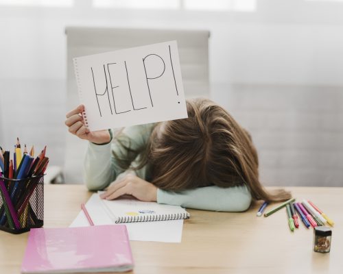 little-girl-holding-help-message-white-paper